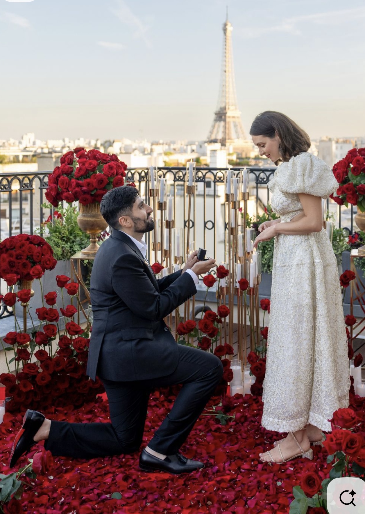 Elegant Paris proposal setup with Eiffel Tower view and candles at night