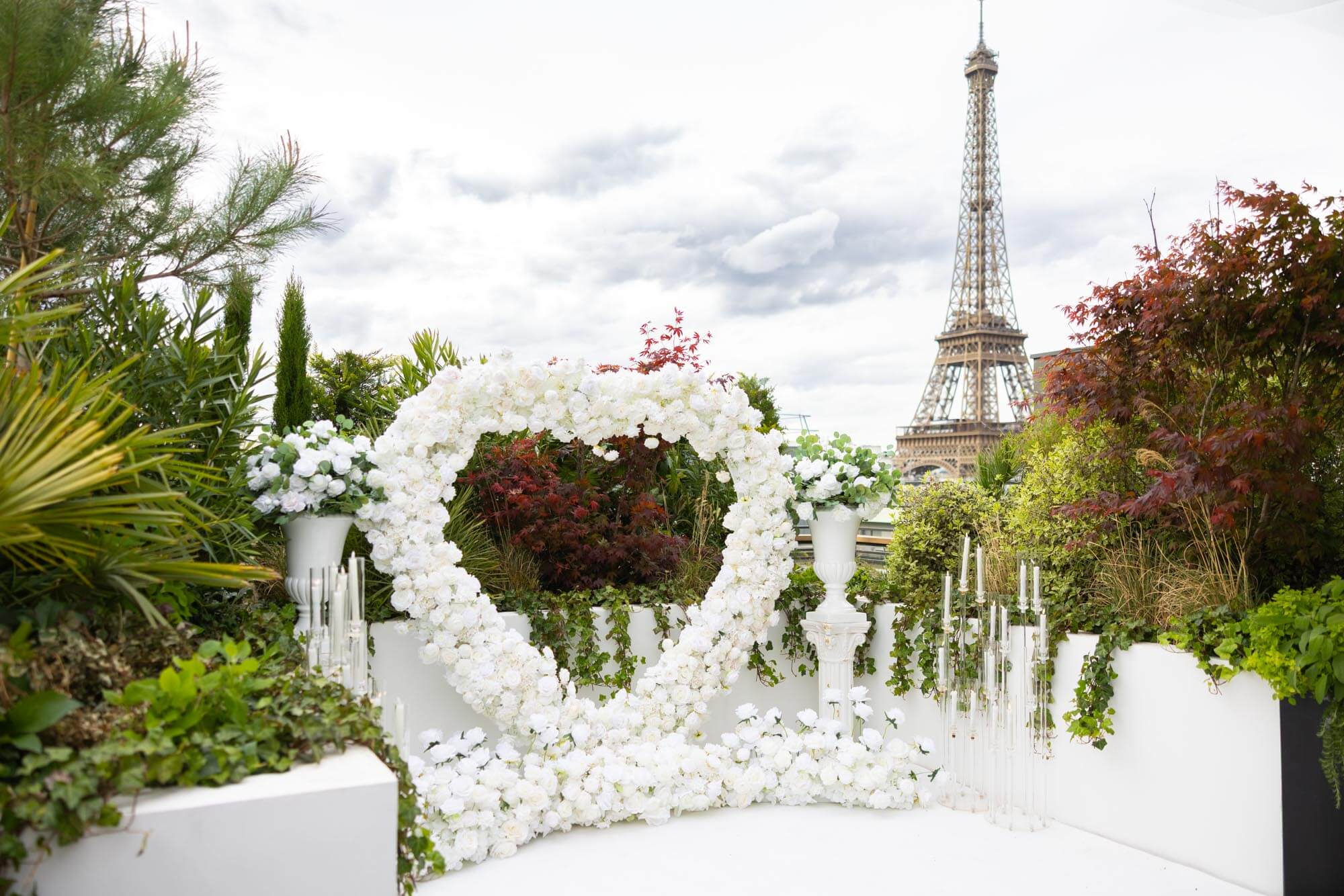 Rooftop proposal with heart-shaped floral design and Eiffel Tower view in Paris