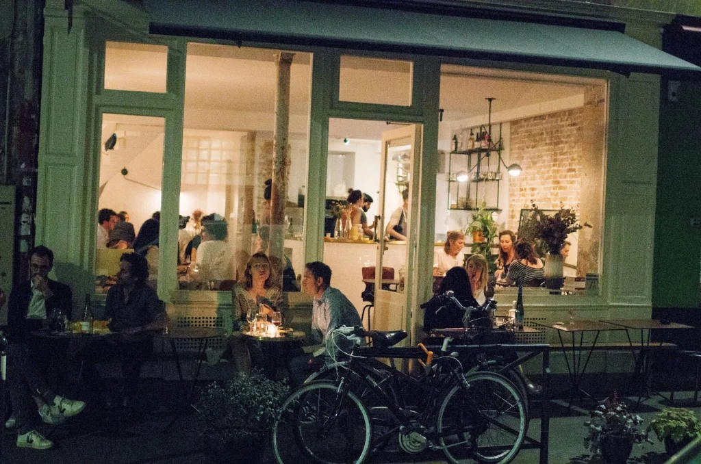 Natural wine bar Early June near Canal Saint-Martin in Paris with open kitchen and guests