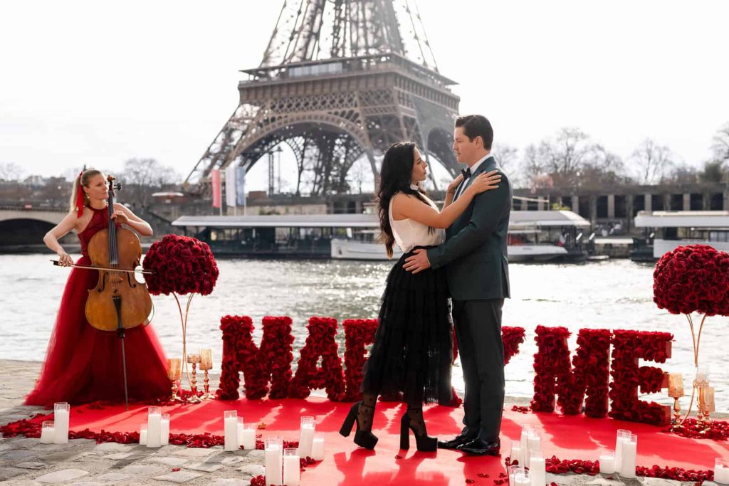 Marriage proposal in Paris on the Seine River with Eiffel Tower view, red marry me letters and live musician