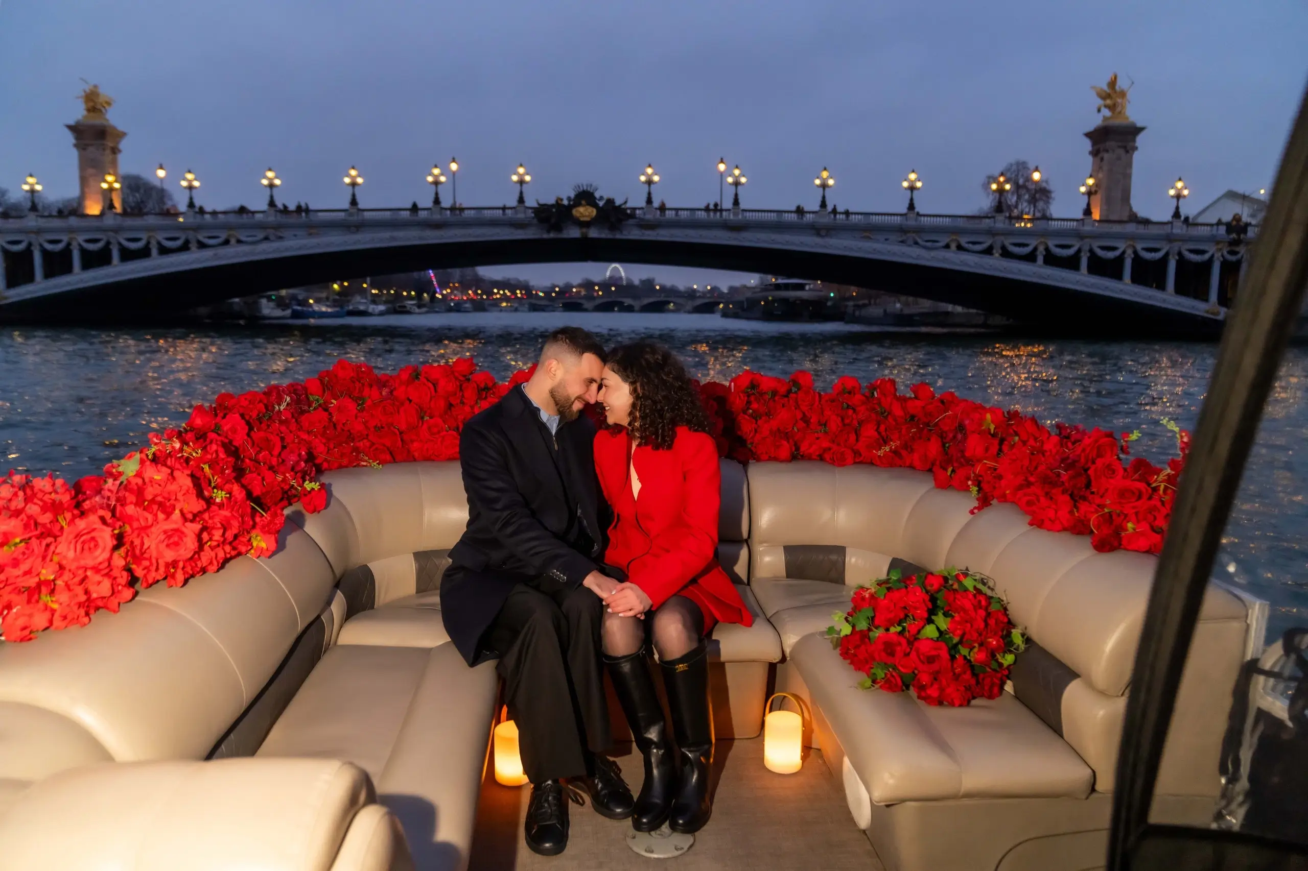 Paris proposal package on a private Seine boat with red roses and candles, Pont Alexandre III at dusk